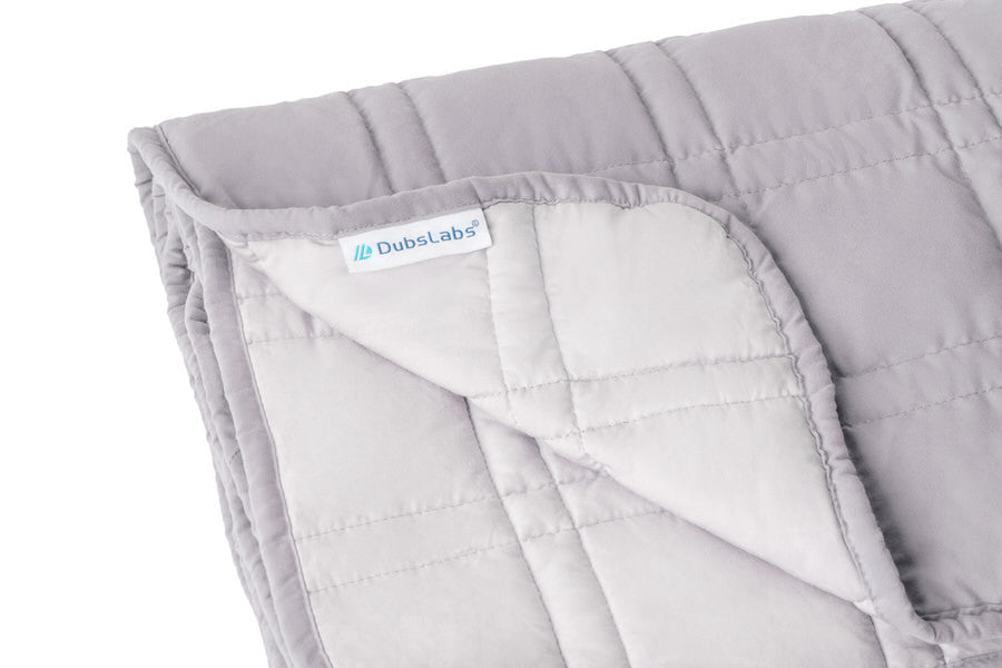 Inner weighted blanket with bamboo side (lighter) and polyester side (darker)