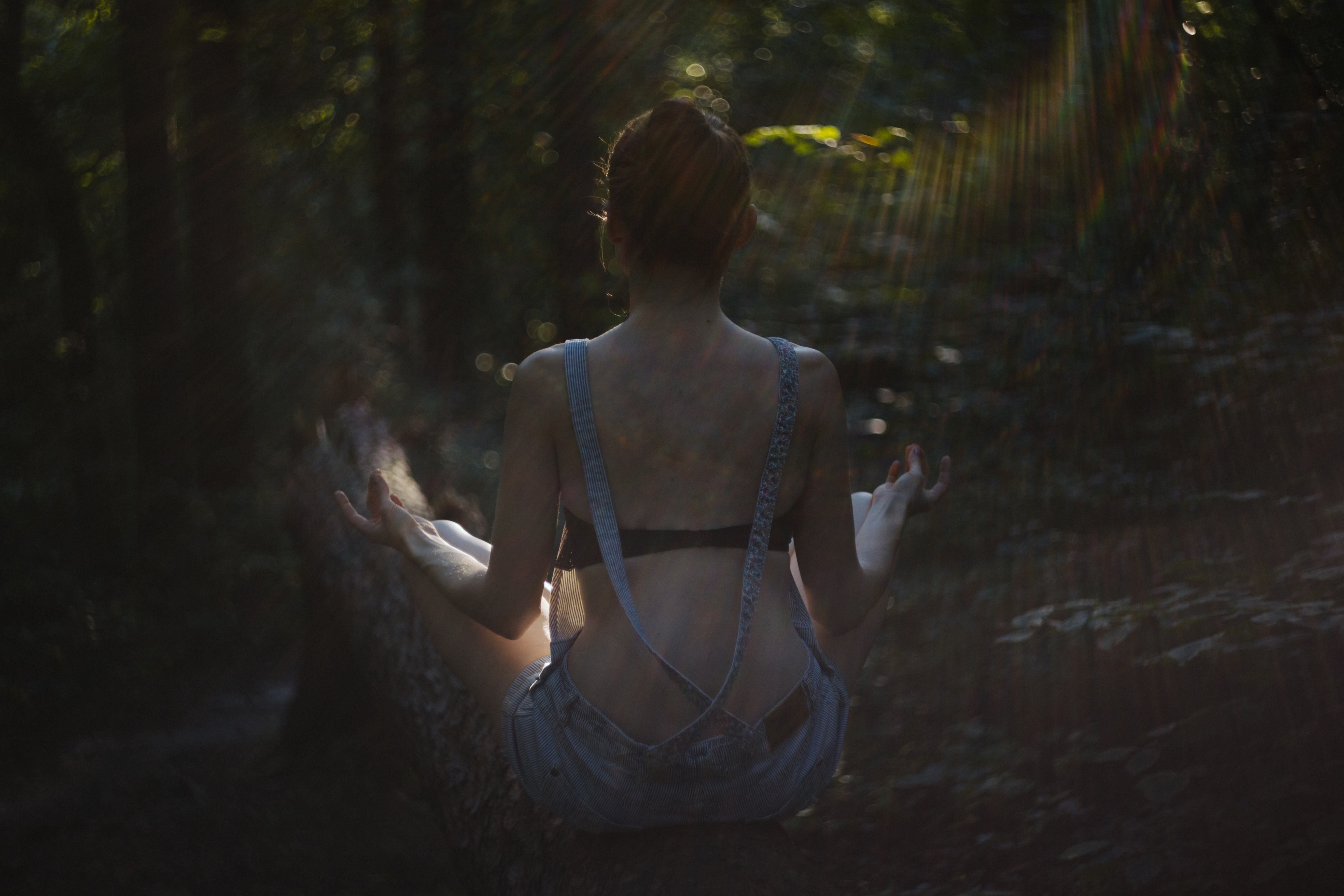 woman meditating in forest