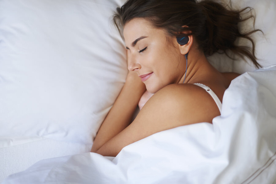 Women Using Bedphones to Get Sound Sleep

